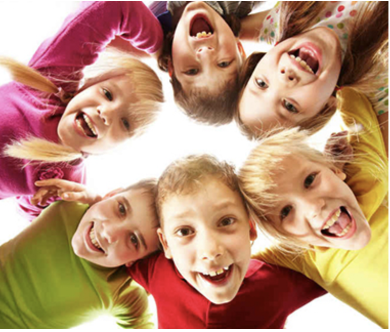 Children in a circle smiling